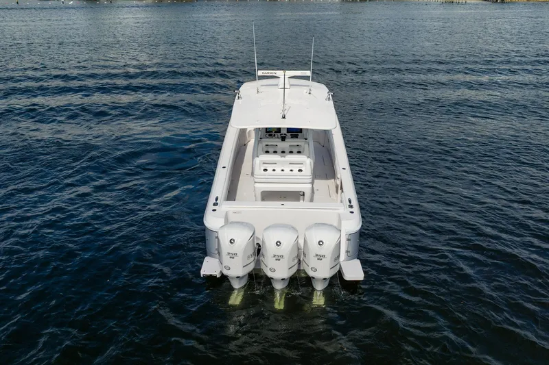 Slide: The Image of 2015 Intrepid 375 Center Console boat with triple engines on open water. - 4