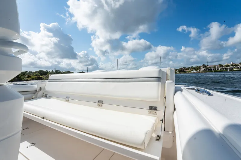 Slide: The Image of 2015 Intrepid 375 Center Console boat with white seating, under a partly cloudy sky. - 8