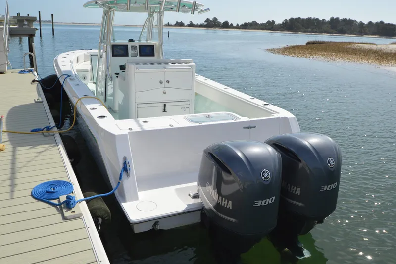 Slide: The Image of 2015 Contender 32 ST boat docked with twin Yamaha 300 engines. - 12