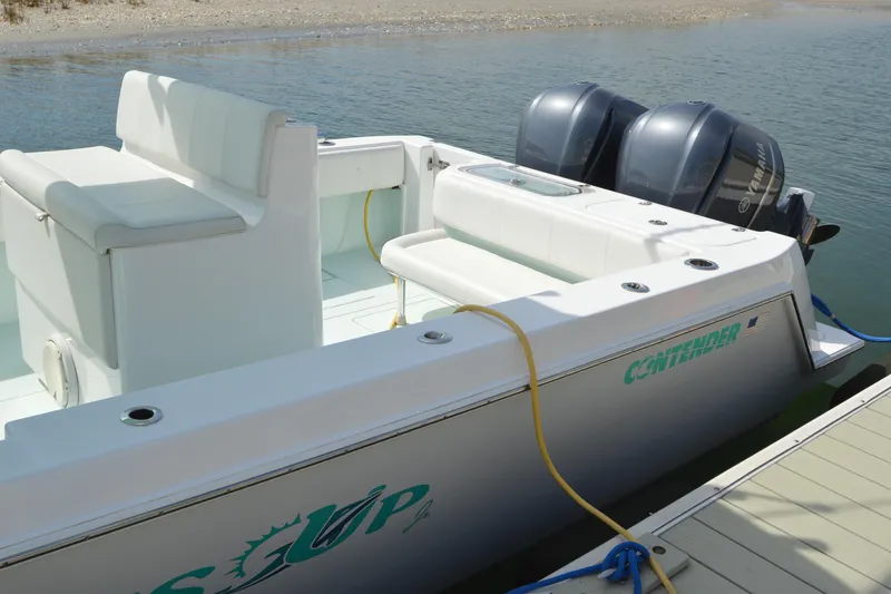 Slide: The Image of 2015 Contender 32 ST boat docked with twin Yamaha engines, featuring spacious seating. - 13