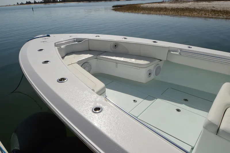 Slide: The Image of 2015 Contender 32 ST boat interior with seating and rod holders on calm water. - 16