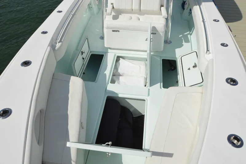 Slide: The Image of 2015 Contender 32 ST boat interior with open storage compartments and seating. - 17