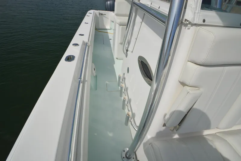 Slide: The Image of 2015 Contender 32 ST boat interior with white seating and stainless steel railings. - 22