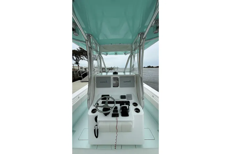 Slide: The Image of 2015 Contender 32 ST boat console with Garmin navigation, docked by the water. - 24