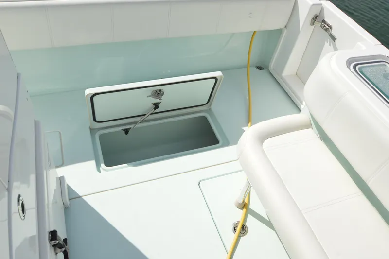 Slide: The Image of 2015 Contender 32 ST boat interior with open storage compartment and seating. - 29
