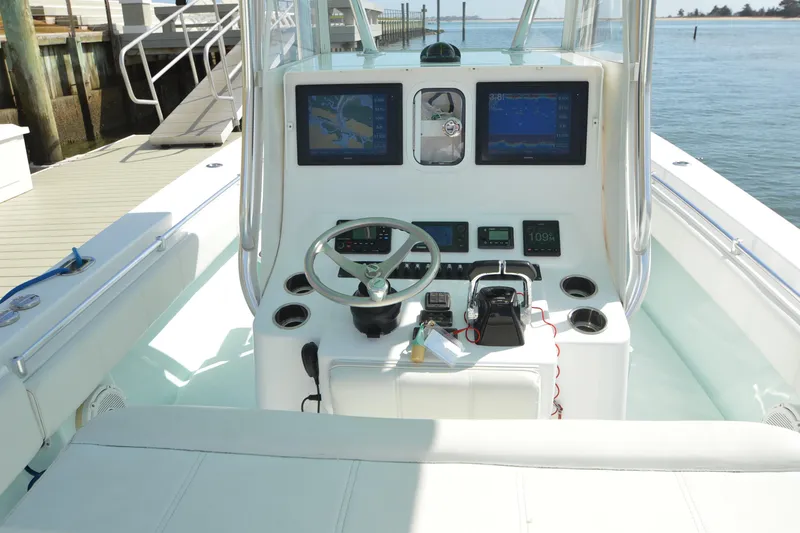 Slide: The Image of 2015 Contender 32 ST boat console with navigation screens and steering wheel. - 3