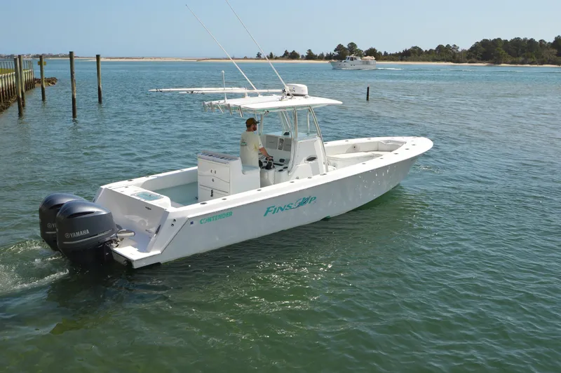 Slide: The Image of 2015 Contender 32 ST boat with dual Yamaha engines cruising on a sunny day. - 7