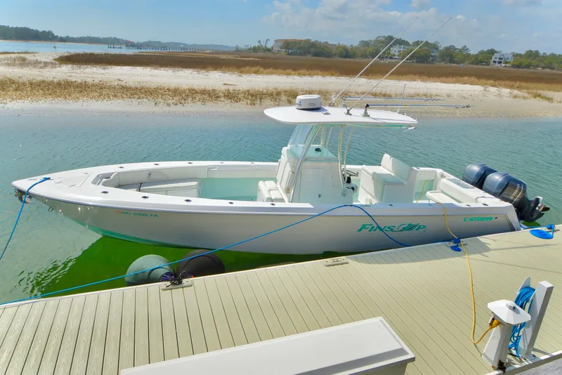 Slide: The Image of 2015 Contender 32 ST boat docked by the shore on a sunny day. - 9