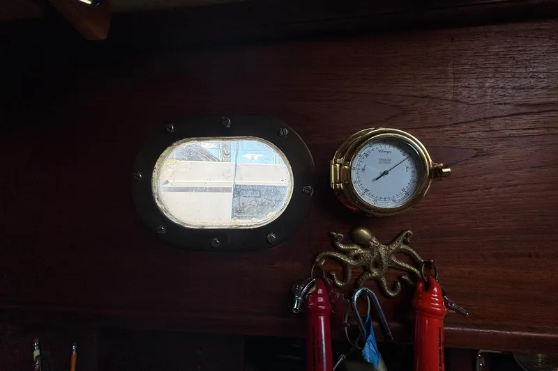 Slide: The Image of Interior of 1977 Pacific Seacraft 31 with porthole, barometer, and nautical decor. - 13
