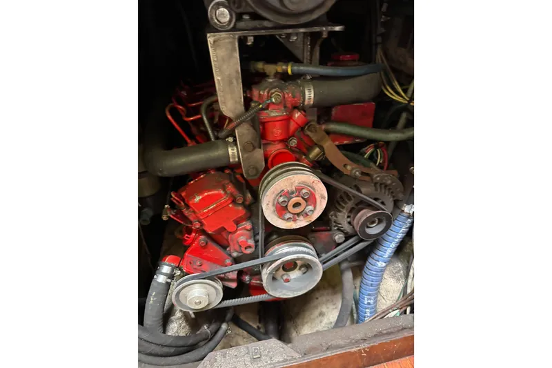 Slide: The Image of Engine of a 1981 Bristol 41.1 Aft Cockpit sailboat, featuring red components and belts. - 16