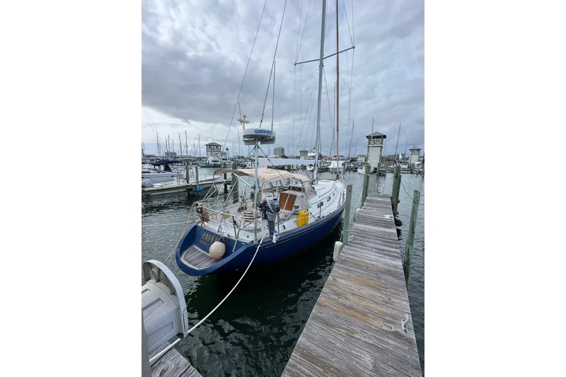 Slide: The Image of 1981 Bristol 41.1 Aft Cockpit sailboat docked at marina under cloudy skies. - 5