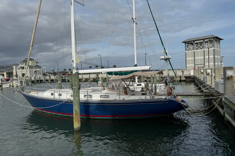 Slide: The Image of 1981 Bristol 41.1 Aft Cockpit sailboat docked at marina under cloudy sky. - 9