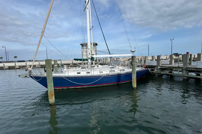 The Image of 1981 Bristol 41.1 Aft Cockpit sailboat docked in a marina under cloudy skies. - 1