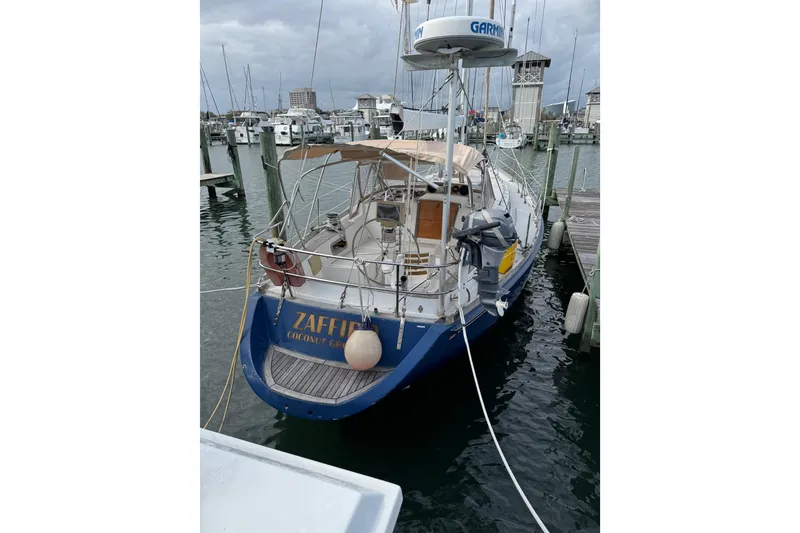 Slide: The Image of 1981 Bristol 41.1 Aft Cockpit sailboat docked at marina, overcast sky. - 10