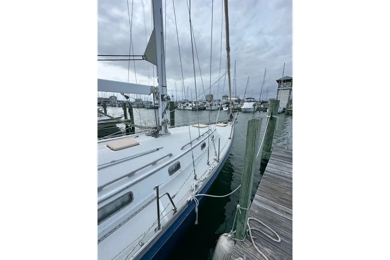Slide: The Image of 1981 Bristol 41.1 Aft Cockpit sailboat docked at marina under cloudy skies. - 4