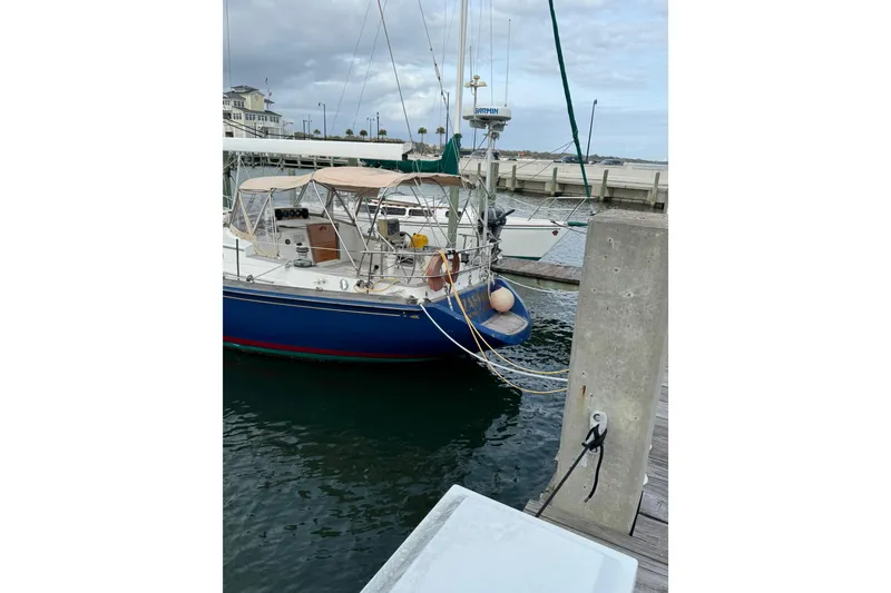 Slide: The Image of 1981 Bristol 41.1 Aft Cockpit sailboat docked at marina, overcast sky. - 7
