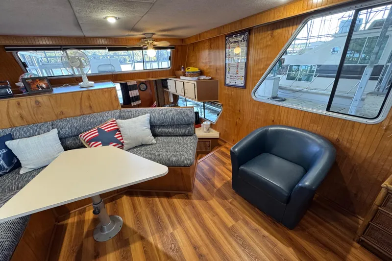 Slide: The Image of Interior of 1993 Gibson 44 Cabin Yacht with cozy seating and wooden paneling. - 19