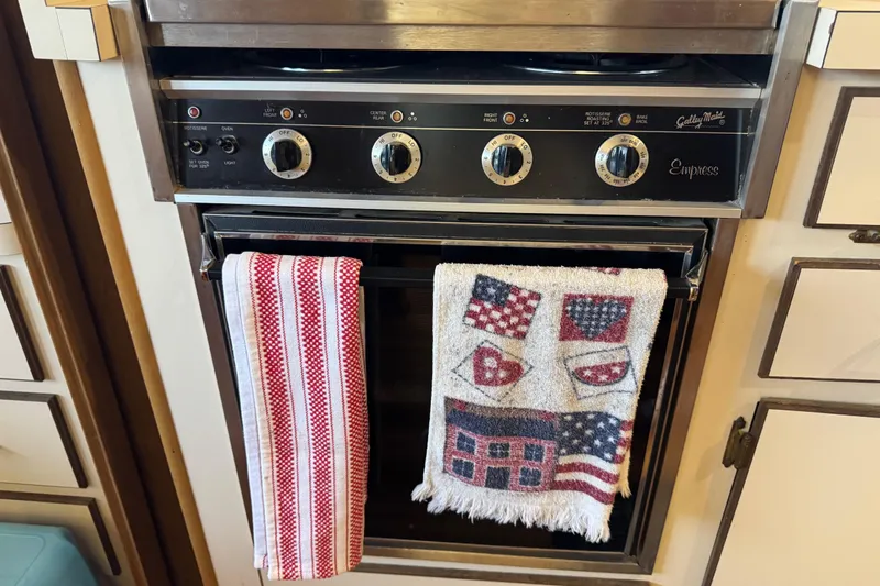 Slide: The Image of Oven with decorative towels in a 1993 Gibson 44 Cabin Yacht kitchen. - 25