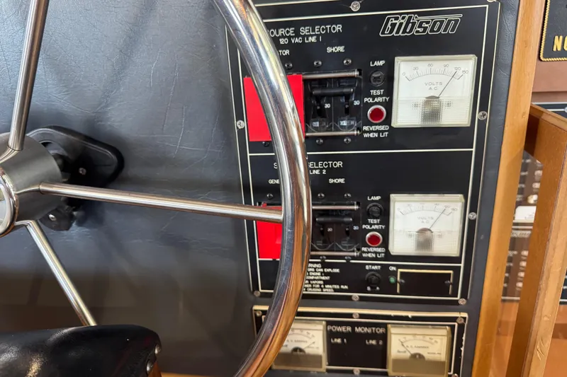Slide: The Image of Control panel of a 1993 Gibson 44 Cabin Yacht with steering wheel and gauges. - 16
