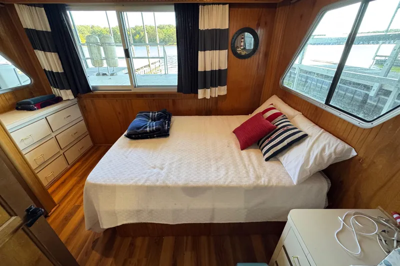 Slide: The Image of Cozy bedroom interior of 1993 Gibson 44 Cabin Yacht with nautical decor and scenic window views. - 29