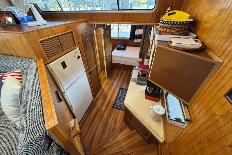 Slide: The Image of Interior of 1993 Gibson 44 Cabin Yacht with wood paneling and cozy furnishings. - 21