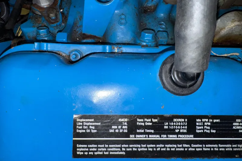 Slide: The Image of Close-up of a blue engine with specifications label on a 1993 Gibson 44 Cabin Yacht. - 46
