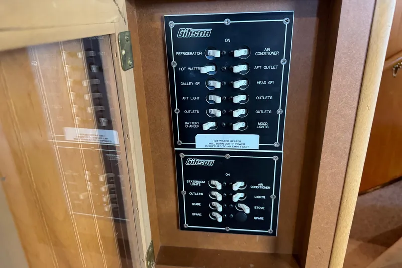 Slide: The Image of Electrical panel of a 1993 Gibson 44 Cabin Yacht with labeled switches. - 17