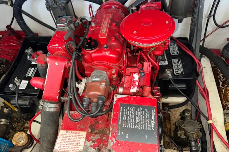 Slide: The Image of Engine compartment of a 1993 Gibson 44 Cabin Yacht with red machinery and wiring. - 47