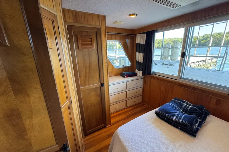 Slide: The Image of Cozy cabin interior of 1993 Gibson 44 Cabin Yacht with wood paneling and lake view. - 30