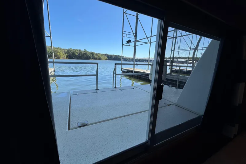 Slide: The Image of View from 1993 Gibson 44 Cabin Yacht, overlooking serene lake and dock. - 32