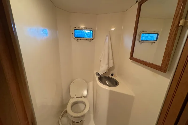 Slide: The Image of Bathroom interior of 1993 Gibson 44 Cabin Yacht with toilet, sink, and mirror. - 38