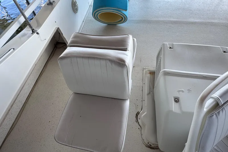 Slide: The Image of 1993 Gibson 44 Cabin Yacht interior with white seating and deck details. - 59