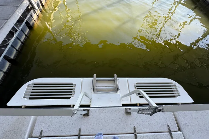 Slide: The Image of Rear view of 1993 Gibson 44 Cabin Yacht swim platform over water. - 66