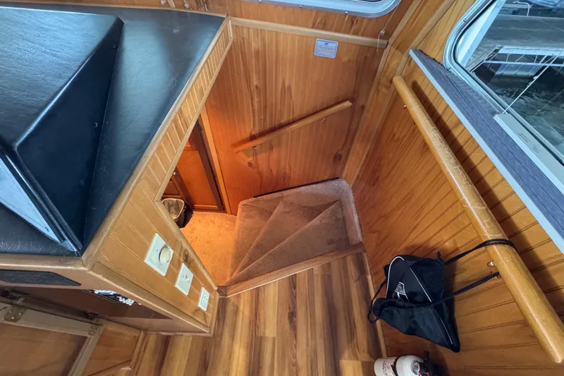 Slide: The Image of 1993 Gibson 44 Cabin Yacht interior with wooden stairs and modern amenities. - 36