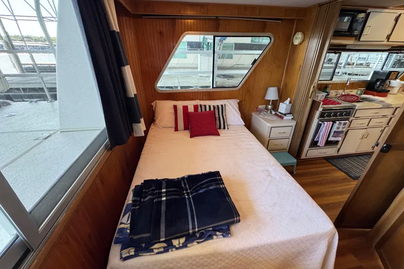 Slide: The Image of Cozy bedroom in 1993 Gibson 44 Cabin Yacht with nautical decor and kitchen view. - 33