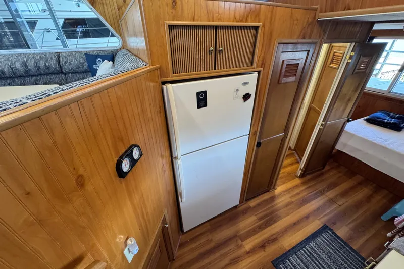 Slide: The Image of Interior of 1993 Gibson 44 Cabin Yacht with wood paneling and refrigerator. - 23