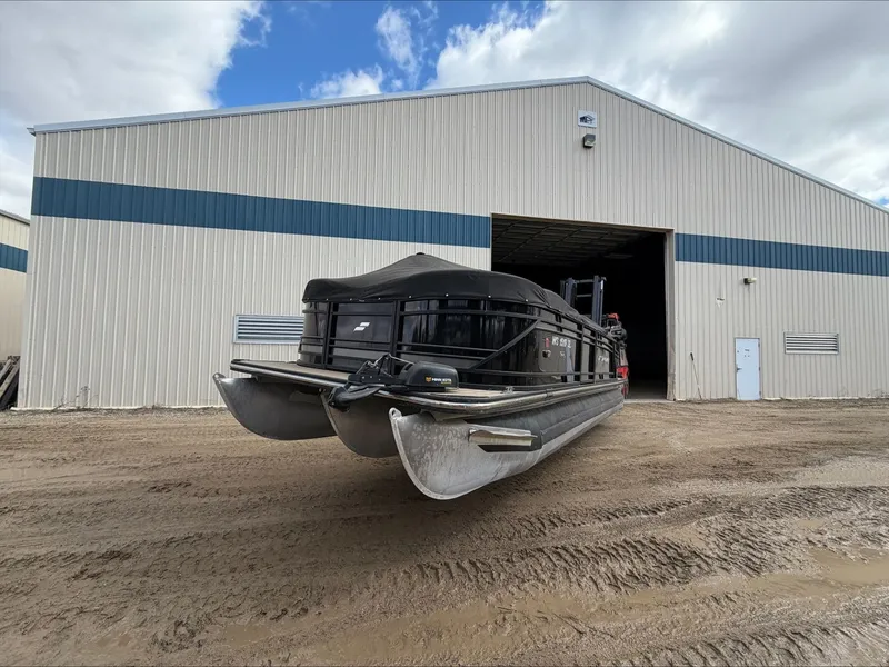 The Image of 2023 Starcraft SLS 3 pontoon boat outside warehouse. - 0