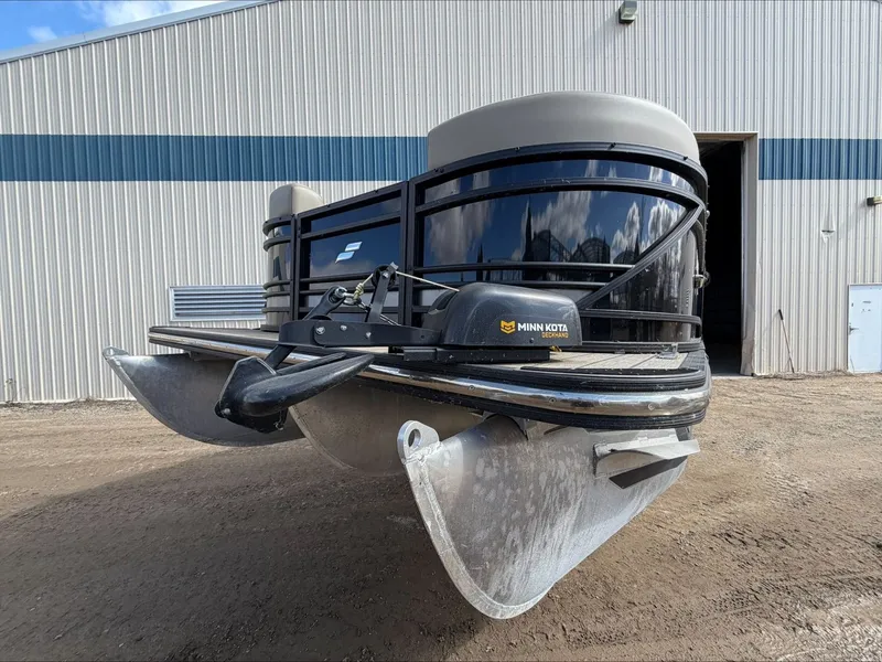 Slide: The Image of 2023 Starcraft SLS 3 pontoon boat in front of a building. - 10