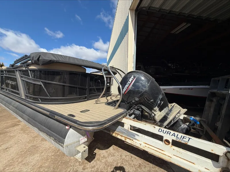 Slide: The Image of 2023 Starcraft SLS 3 pontoon boat with Mercury engine on trailer. - 12