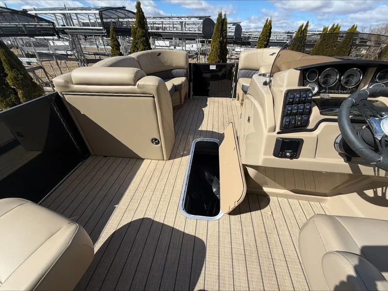 Slide: The Image of Interior of a 2023 Starcraft SLS 3 boat with beige seating and control console. - 25