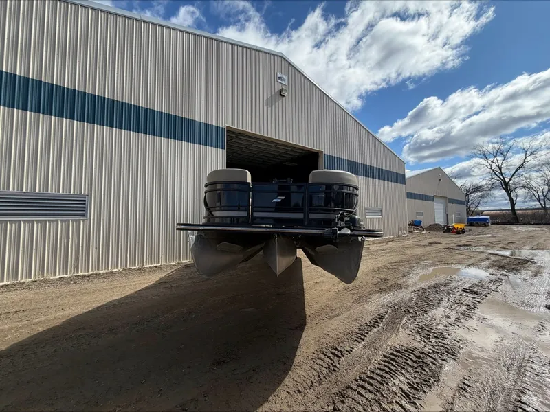 Slide: The Image of 2023 Starcraft SLS 3 pontoon boat outside warehouse. - 3