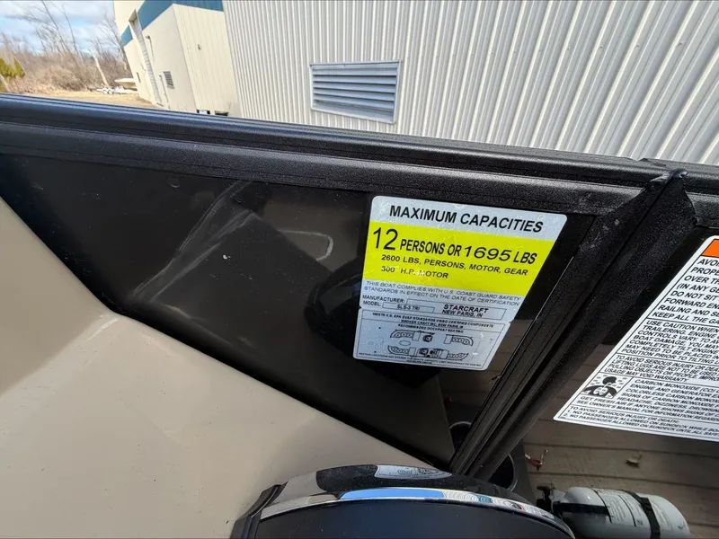 Slide: The Image of Starcraft SLS 3 boat capacity label, 12 persons or 1695 lbs, year 2023. - 31