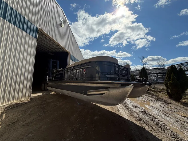 Slide: The Image of Starcraft SLS 3 pontoon boat 2023 exiting warehouse under sunny skies. - 9