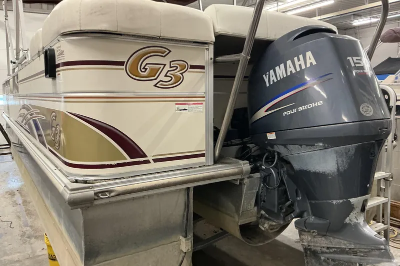 Slide: The Image of 2008 SunCatcher LX3 26 DC pontoon boat with Yamaha 150 four-stroke engine in a garage. - 3