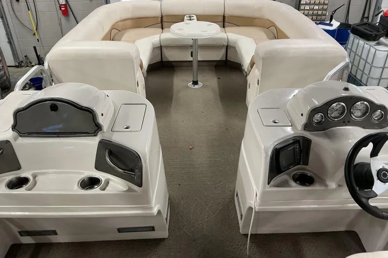 Slide: The Image of Interior of a 2008 SunCatcher LX3 26 DC pontoon boat with seating and control panels. - 7