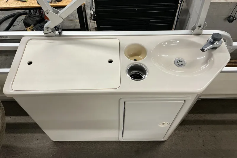 Slide: The Image of 2008 SunCatcher LX3 26 DC boat sink and countertop with faucet and storage cabinet. - 9