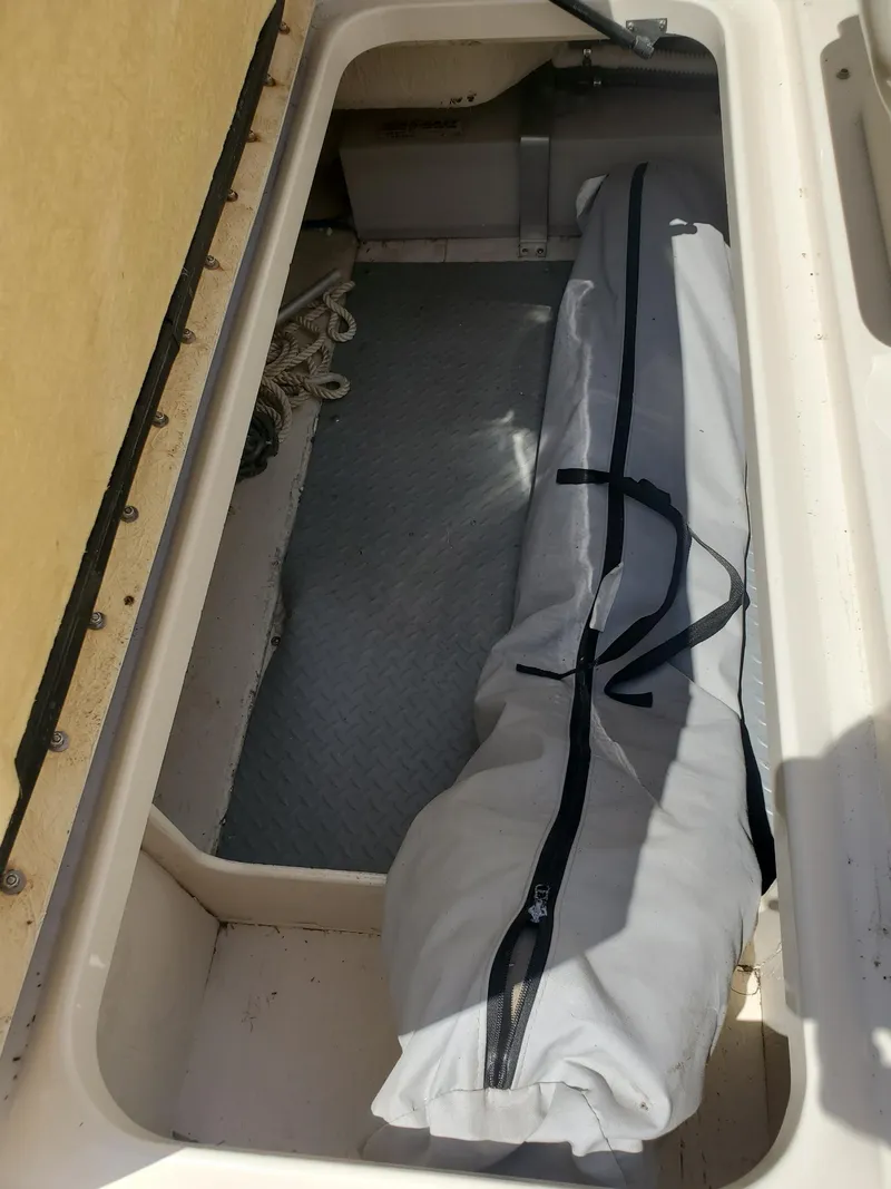 Slide: The Image of Storage compartment of 2001 Sea Ray 245 Weekender boat with covered equipment. - 15