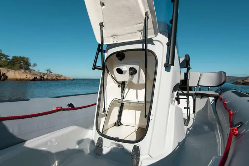 Slide: The Image of Manufacturer Provided Image: Zodiac Open 5.5 boat 2026 with open storage compartment by the sea. - 3