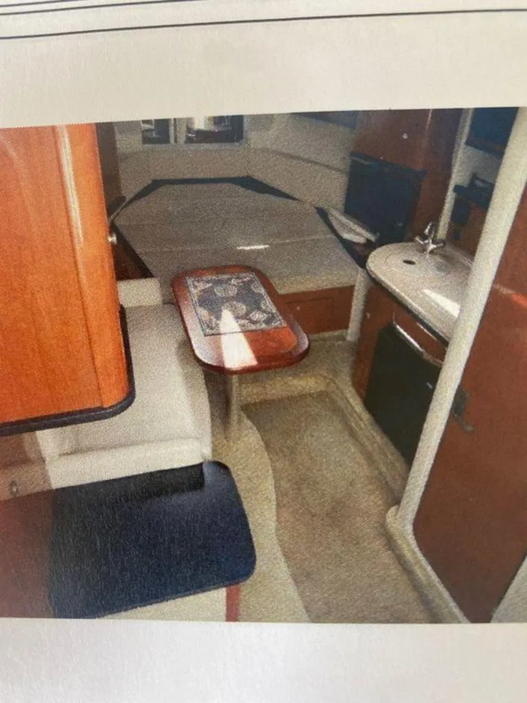 Slide: The Image of Interior of 2007 Sea Ray 290 Sundancer with kitchenette and seating area. - 11
