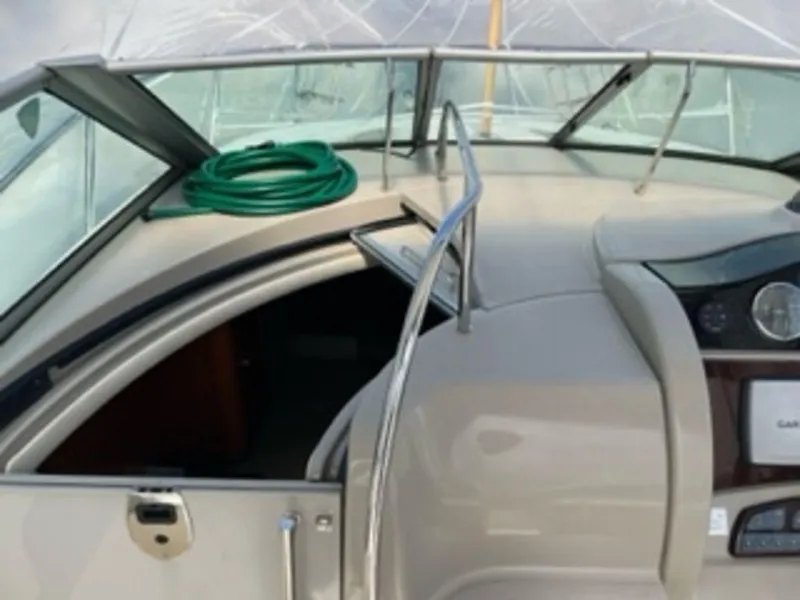 Slide: The Image of 2007 Sea Ray 290 Sundancer boat with cockpit and hose. - 4